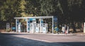 Young man walks past a small Tamoil town fuel service station in Milan