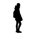Young man in warm jacket, jeans and sneakers standing. Black silhouette isolated on white background. Side view Royalty Free Stock Photo