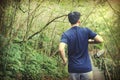 Young man warming up and going to run in the forest trail Royalty Free Stock Photo