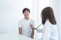 A young man was examined by a female doctor with a stethoscope on his chest Royalty Free Stock Photo