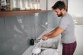 Man washes dishes after breakfast