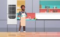 Young man washing dishes african american guy wiping plates doing housework dishwashing concept modern kitchen interior