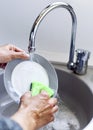 Young man washing dishes Royalty Free Stock Photo