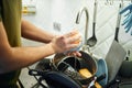 Young man washing dishes in the kitchen. Royalty Free Stock Photo