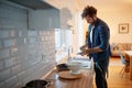 Young man washing dishes in the kitchen. Kitchen, housework, quarantin, home Royalty Free Stock Photo