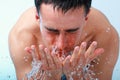 Young man washing face. Royalty Free Stock Photo