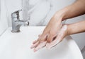 Young man washing hands over sink in bathroom, closeup, Corona virus or Covid-19 prevention, hygiene to stop. Royalty Free Stock Photo