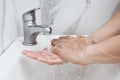 Young man washing hands over sink in bathroom, closeup, Corona virus or Covid-19 prevention, hygiene to stop. Royalty Free Stock Photo