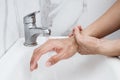 Young man washing hands over sink in bathroom, closeup, Corona virus or Covid-19 prevention, hygiene to stop. Royalty Free Stock Photo