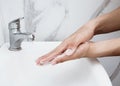 Young man washing hands over sink in bathroom, closeup, Corona virus or Covid-19 prevention, hygiene to stop. Royalty Free Stock Photo