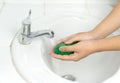 Young man washing hands with soap on white basin Royalty Free Stock Photo