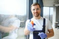 Young man washing window in office Royalty Free Stock Photo