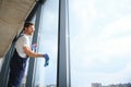 Young man washing window in office Royalty Free Stock Photo