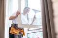 Young man washing window in office Royalty Free Stock Photo