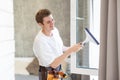 Young man washing window in office Royalty Free Stock Photo