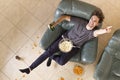Top view of man with beer and chips and popcorn watching TV at home Royalty Free Stock Photo