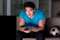 The young man watching football late at night Royalty Free Stock Photo