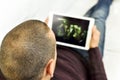 Young man watching a movie or a series in his tablet Royalty Free Stock Photo