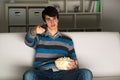 Young man watching television with popcorn Royalty Free Stock Photo