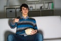 Young man watching television with popcorn Royalty Free Stock Photo