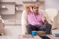 Young man watching tv at home during pandemic Royalty Free Stock Photo