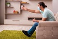 Young man watching tv at home during pandemic Royalty Free Stock Photo