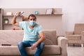 Young man watching tv at home during pandemic Royalty Free Stock Photo