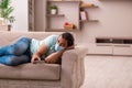 Young man watching tv at home during pandemic Royalty Free Stock Photo