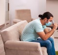 Young man watching tv at home during pandemic Royalty Free Stock Photo