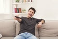 Young man watching tv using remote controller Royalty Free Stock Photo