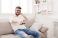 Young man watching tv using remote controller Royalty Free Stock Photo