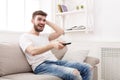 Young man watching tv using remote controller Royalty Free Stock Photo