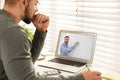 Young man watching video at desk. Online learning