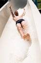 Young man on water slide Royalty Free Stock Photo