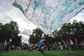 Young man waving giant flag at Extinction Rebellion Protest at Parliament square