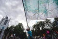 Young man waving giant flag at Extinction Rebellion Protest at Parliament square