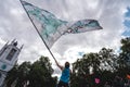 Young man waving giant flag at Extinction Rebellion Protest at Parliament square