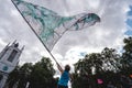 Young man waving giant flag at Extinction Rebellion Protest at Parliament square