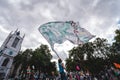 Young man waving giant flag at Extinction Rebellion Protest at Parliament square