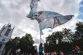 Young man waving giant flag at Extinction Rebellion Protest at Parliament square