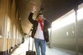 Young man waving hand at train station Royalty Free Stock Photo