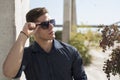 Young man wear sunglasses lean on a colum Royalty Free Stock Photo