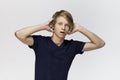 Portrait of young man wearing black t-shirt with shocked and worried facial expression against white background Royalty Free Stock Photo