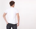 Young man wearing blank t shirt isolated on white background. Copy space. Place for advertisement. Back view Royalty Free Stock Photo