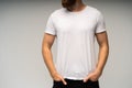 Young man wearing blank white t-shirt isolated on white background. Copy space. Place for advertisement. Front view. Royalty Free Stock Photo