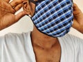 Young man wearing blue color checked cloth face mask