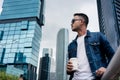 Young man wearing blue denim jacket while daydreaming outdoors i Royalty Free Stock Photo