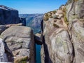 Norway - Young man squatting on Kjerag