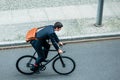 Young man wearing business suit while riding an utility bicycle Royalty Free Stock Photo