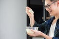 A young man wearing casual clothing use a whisk mixing ingredients in a bowl while standing in the kitchen. Kitchen tools. Royalty Free Stock Photo